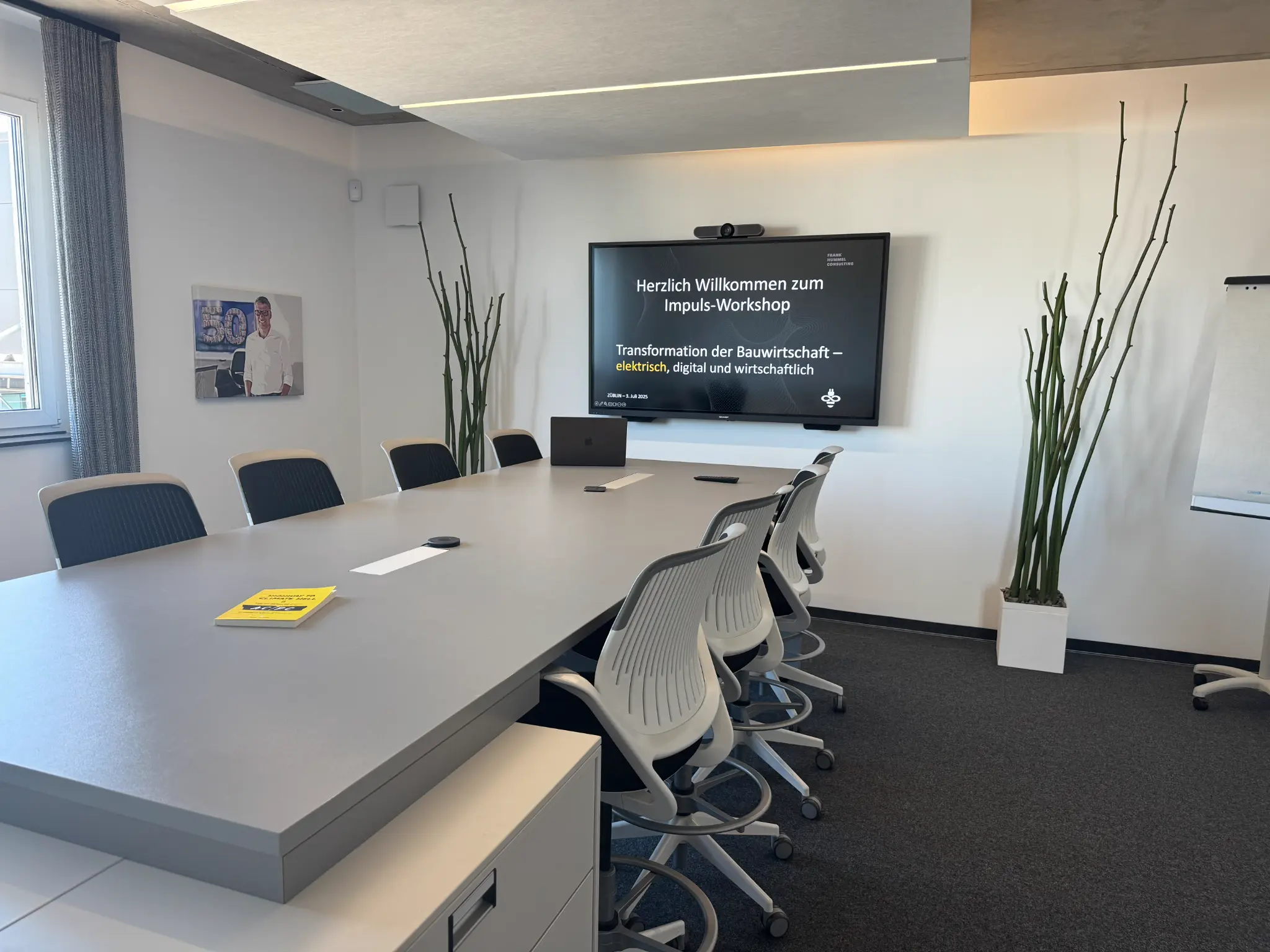 Meeting room at HSG Innovation HUB with conference table and presentation screen